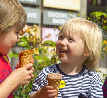 Two kids eating ice cream at Eden Project